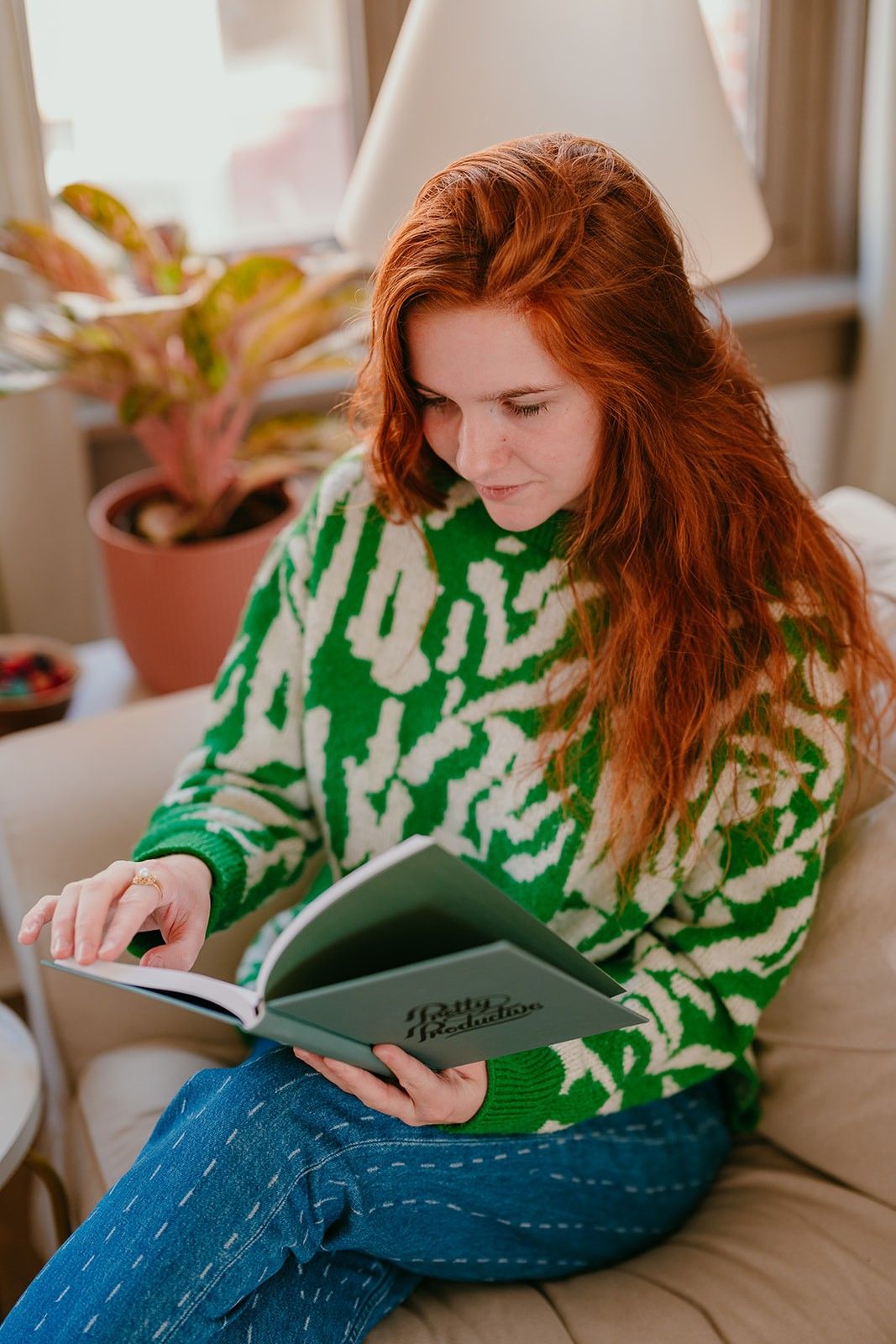 Yasmine, the founder of Learn Dutch with Yas, reading a Dutch vocabulary book